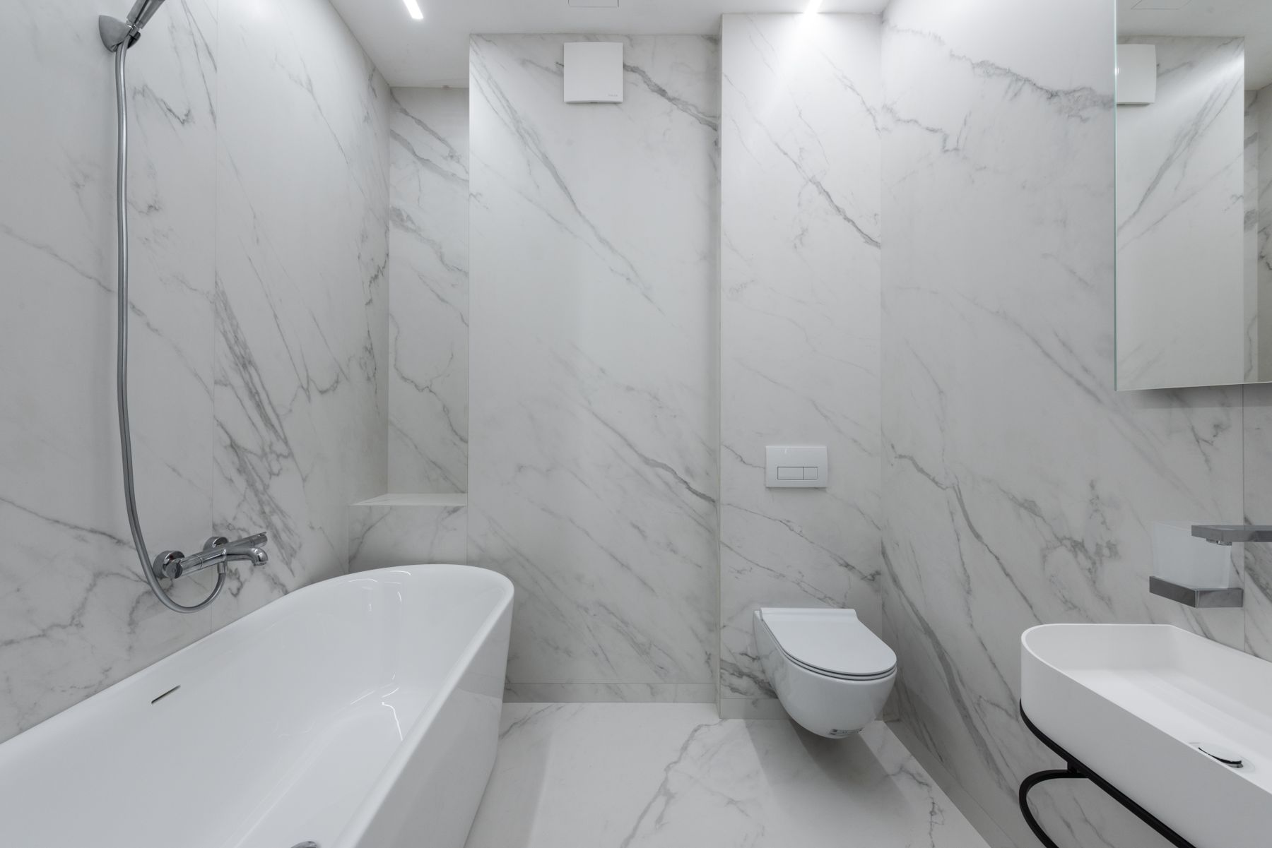 A bathroom with a wall-hung toilet and basin